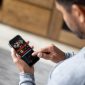 Man gambling online on a football match using his cell phone - lifestyle concepts