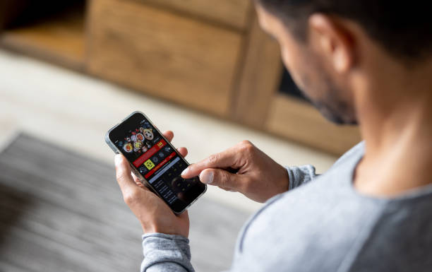 Man gambling online on a football match using his cell phone - lifestyle concepts